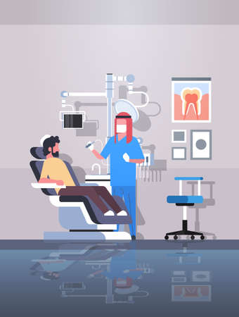 male arab dentist drilling teeth of man patient lying in dentistry chair professional dental office modern clinic interior arabic characters full length flat vertical vector illustrationのイラスト素材