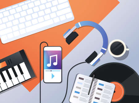 smartphone playing music via headphones audio mobile app concept top angle view workplace desktop...