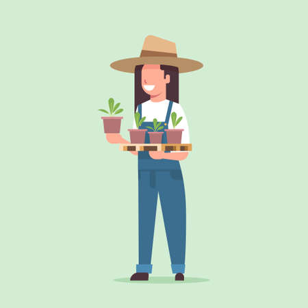 female farmer holding potted plants woman in uniform planting young seedlings in garden agricultural worker eco farming concept flat full length vector illustrationのイラスト素材