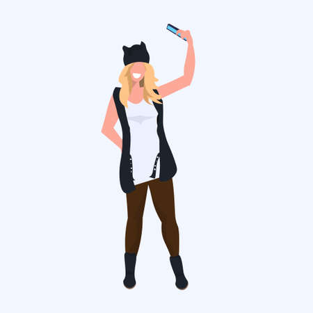 woman taking selfie photo on smartphone camera casual female cartoon character girl model standing pose flat full length vector illustrationのイラスト素材