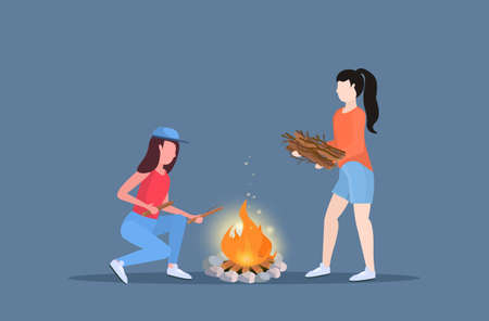 women hikers making fire couple girls holding firewood for bonfire hiking camping concept travelers on hike horizontal full length flat vector illustrationのイラスト素材