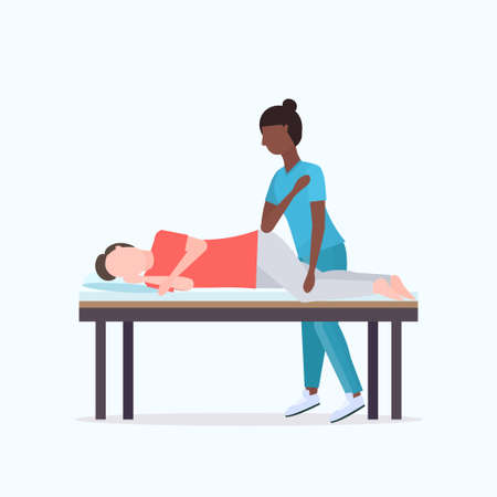 guy lying on massage bed african american masseuse therapist doing healing treatment massaging injured patient manual sport physical therapy rehabilitation concept full length vector illustrationのイラスト素材
