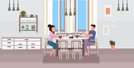 young couple having breakfast man woman sitting at table eating food together modern home kitchen interior flat horizontal full length vector illustrationのイラスト素材