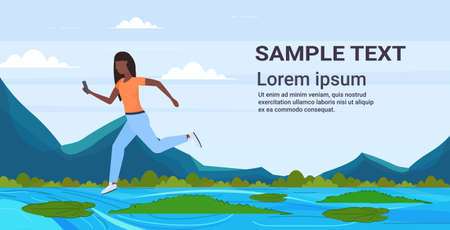 brave african american woman using smartphone jumping over lotus leaves on river with crocodiles risk and danger determination digital addiction concept full length horizontal copy space flat vector illustrationのイラスト素材