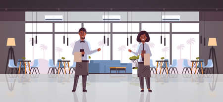 professional waiters couple holding menu warmly welcoming to cozy restaurant man woman workers in...