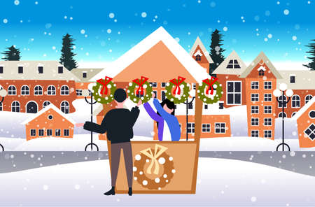 man buying green wreath with red bow in stall with female seller christmas market winter fair concept happy new year merry xmas holidays celebration cityscape background full length sketch horizontal vector illustrationのイラスト素材