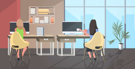 businesswomen couple sitting at workplace desk business women using computer drinking coffee coworking center modern open space office interior rear view full length horizontal vector illustrationのイラスト素材