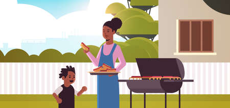 mother and son preparing hot dogs on grill happy african american family having fun backyard picnic barbecue party concept flat portrait horizontal vector illustrationのイラスト素材