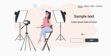 woman beauty blogger recording video blog with digital camera on tripod live streaming social media...