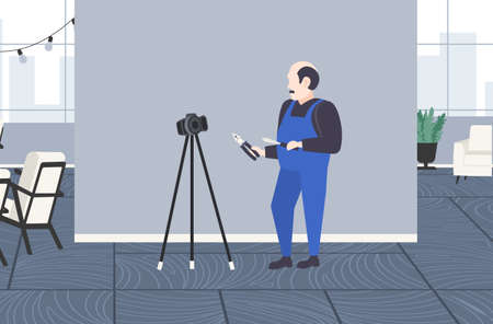 handyman worker with screwdriver and cutting pliers blogger recording online video with digital...
