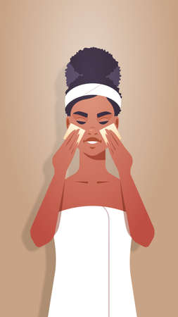 young woman applying foundation cream with spongers dressed in towel african american girl cleaning and care her face skincare spa relax facial treatment concept portrait vertical vector illustrationのイラスト素材