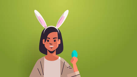 woman wearing bunny ears cute girl holding egg celebrating happy easter holiday
