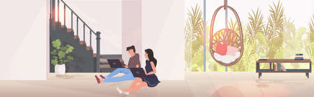 man woman using laptops couple sitting on floor spending time together modern living room interior horizontal full length vector illustrationのイラスト素材