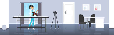 female veterinarian blogger checking dog at veterinarian clinic woman recording online video with camera on tripod blogging concept modern vet clinic interior horizontal full lengthのイラスト素材