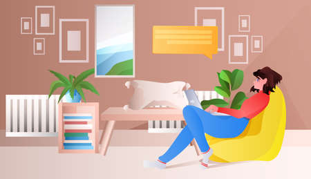 woman sitting on beanbag and using laptop chat bubble communication social media network concept horizontal full length vector illustrationのイラスト素材