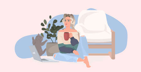 beautiful young girl drinking coffee and working on laptop woman sitting on floor with catのイラスト素材