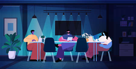 overworked businesspeople discussing during meeting in modern dark night office horizontal full...