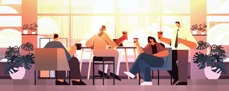 mix race businesspeople sitting at cafe table and drinking coffee during meeting modern cafeteria...