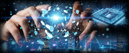 A close-up of hands reaching out towards a glowing digital interface filled with particles and data streams, with a microchip in the background.の写真素材