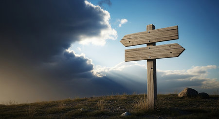 Wooden signpost on the mountain with dramatic sky and clouds.の素材