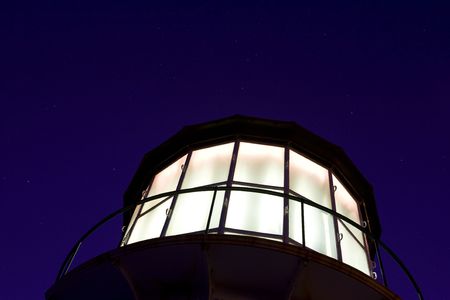 Fresnel lens lighthouse against a star filled skyの写真素材