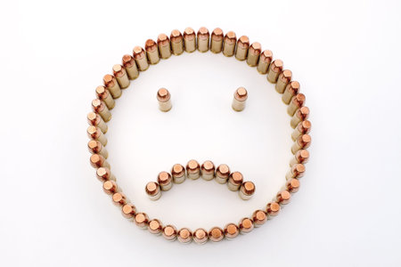 several gun bullets forming an unhappy face