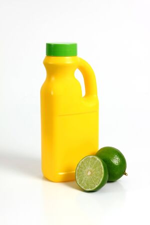 yellow plastic container with a whole lemon and a chopped in halfの写真素材