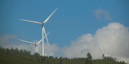 Modern white wind turbine or wind mill producing clean energy の写真素材