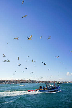 PENICHE, PORTUGAL - JULY 9: View of fishing boat returning to harbor July 9, 2012 in Peniche, Portugalのeditorial素材