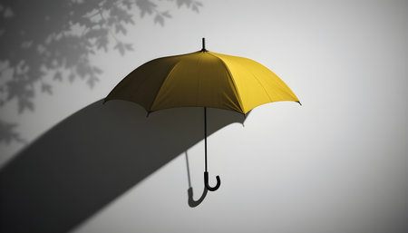 Yellow umbrella hanging on a wall with shadow, 3d render.の素材