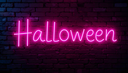 Halloween neon sign on brick wall background. Night neon signboard.の素材