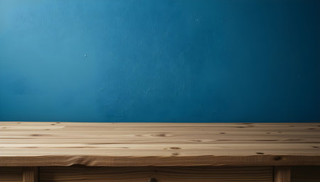 Empty wooden table over blue wall background, for product display montageの素材