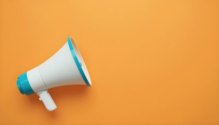 White megaphone on orange background with copy space for text.の素材