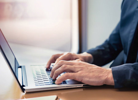 Businessman using laptop, Close-up of hand with holographic cinema light graphics generative ai illustrationの素材