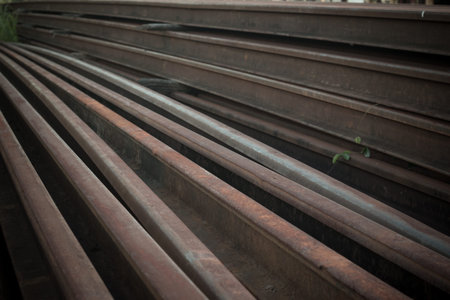 Steel tracks piled together beside the tracks
