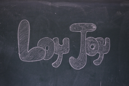 Blackboard with the first letters of the alphabet written on itの写真素材