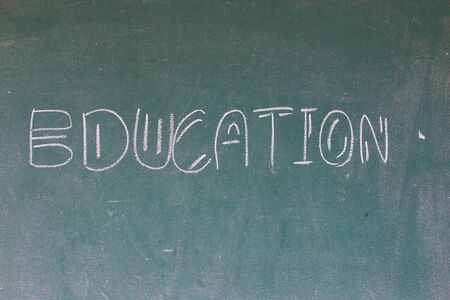 Blackboard with the first letters of the alphabet written on itの写真素材
