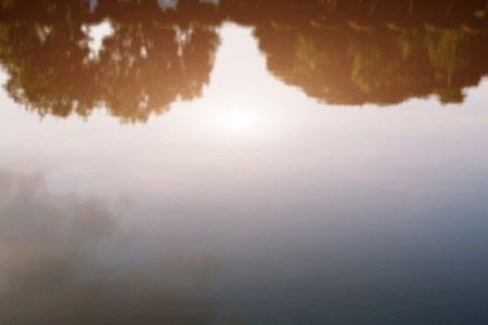The sky reflected in the water with the evening light.の写真素材