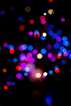 Colorful bokeh circle light celebrate at night, defocus light abstract blue background.の写真素材