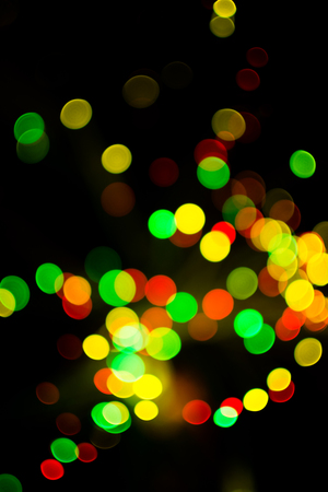 Colorful bokeh light celebrate at night, defocus light abstract yello background.の写真素材