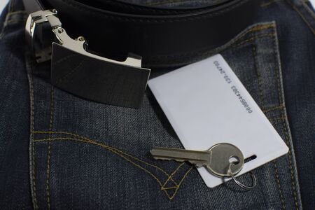 Key card and room key on clothing accessories.の写真素材