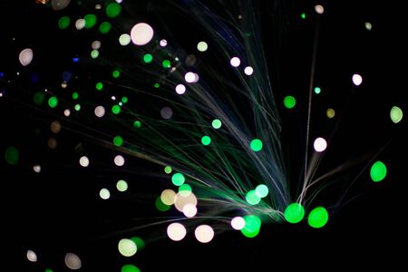 Colorful bokeh circle light celebrate at night, defocus light abstract green background.の写真素材