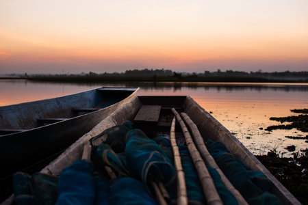 Wood boat moored on the river with the sunset.の写真素材