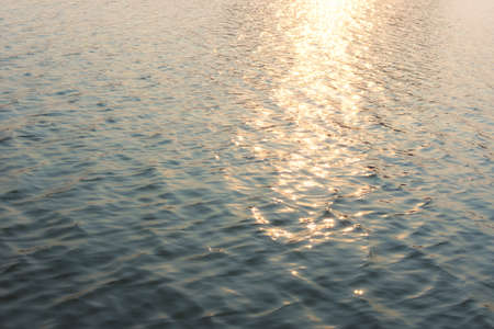 Sunlight reflecting and sparkling on river.の写真素材