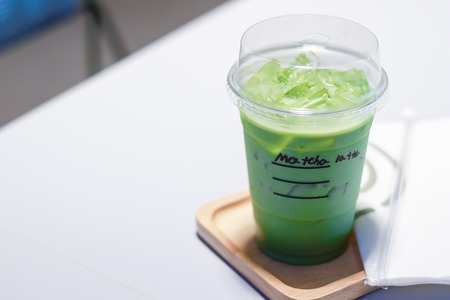 Iced matcha green tea latte on table in store.の写真素材