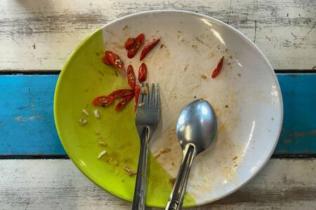 Rice plate after eating out, placed on the tableの写真素材