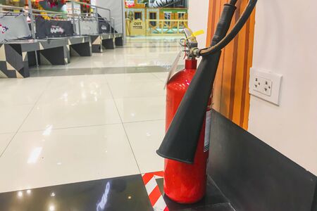 The red fire extinguisher is in the building for fire prevention and safety.の写真素材