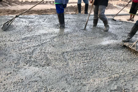 Workers pouring reinforced concrete floors on siteの写真素材