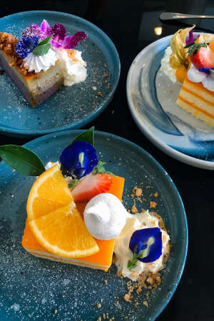 Orange cake with orange topping on plate ready to eatの写真素材
