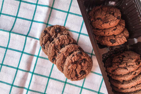 Chocolate cookies in packaging on cloth background.の写真素材